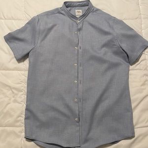 Light blue, no collar, button down.